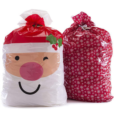 Ecoの白い雪片の印刷物が付いている友好的で大きいプラスチック クリスマスのギフト袋